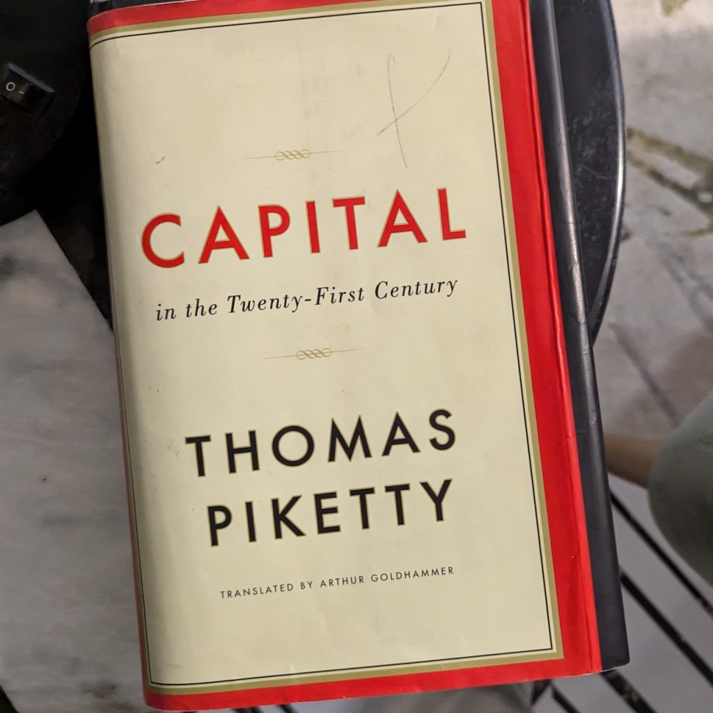 Capital in the 21st Century by Thomas Piketty sitting on a table.